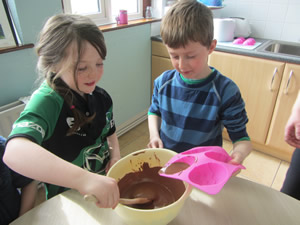Pupils making chocolate buns in kitchen at St Aidans NS Ballintrillick