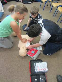 Pupils at St Aidans practicing CPR on a dummy