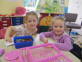 Girls playing with their crayons at St Aidans School Ballintrillick