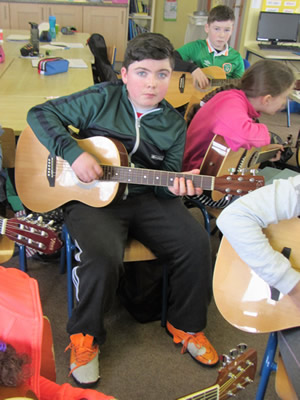 Pupil learning guitar at St. Aidans Ballintrillick