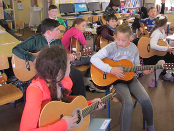 Children at St Aidans School playing the guitar