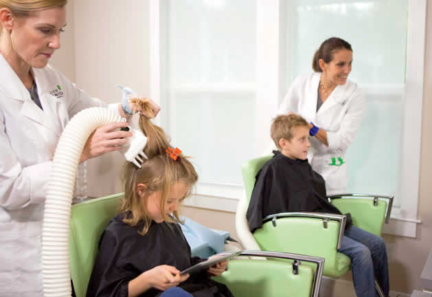 Lady treating headlice on child