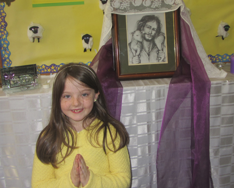 Pupil praying at St Aidans National School Ballintrillick